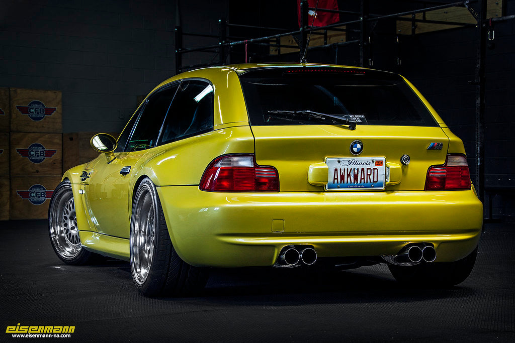Eisenmann E36/7 Z3M performance exhaust system with polished metal finish and dual tailpipes, mounted on a car.
