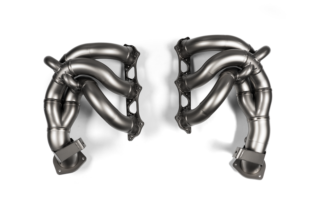 Akrapovic titanium exhaust header set for Porsche 718 Cayman GT4 RS and Spyder RS (982) shown from overhead angle.