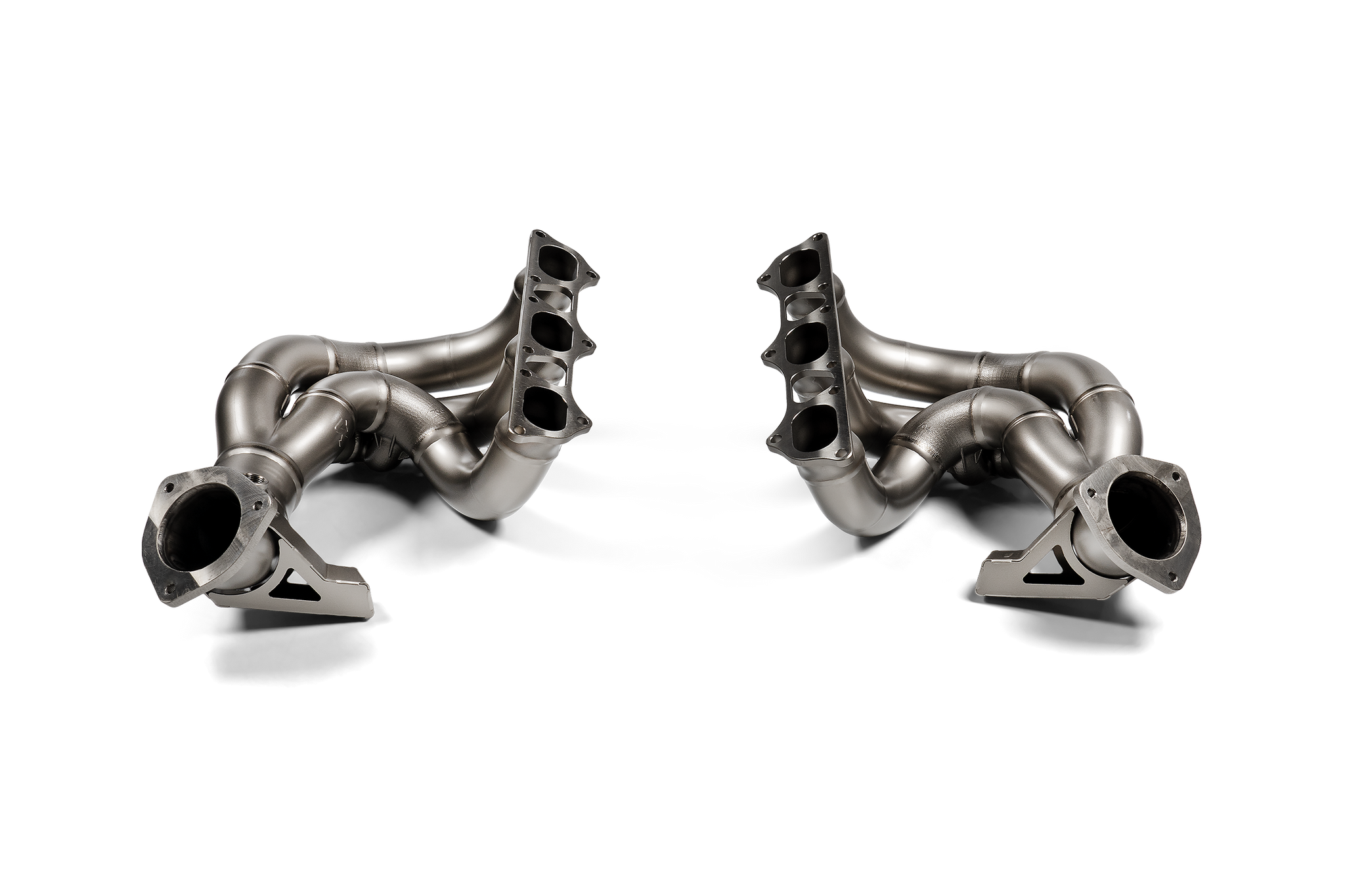 Akrapovic titanium exhaust header set for Porsche 718 Cayman GT4 RS and Spyder RS (982) models, showcasing sleek metallic design.