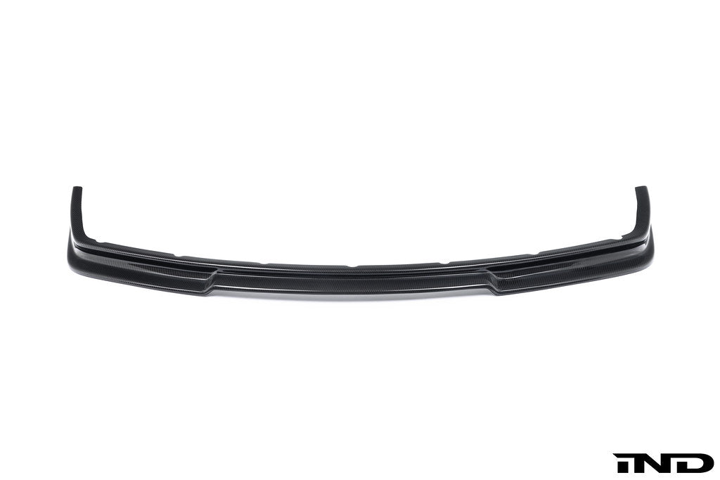 Alpha N E36 M3 Carbon GT front lip installed on a white background, showcasing its sleek exterior design and carbon fiber finish.