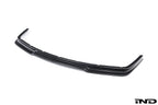 Alpha N E36 M3 Carbon GT front lip installed on white background, showcasing its sleek exterior design and lightweight carbon construction.