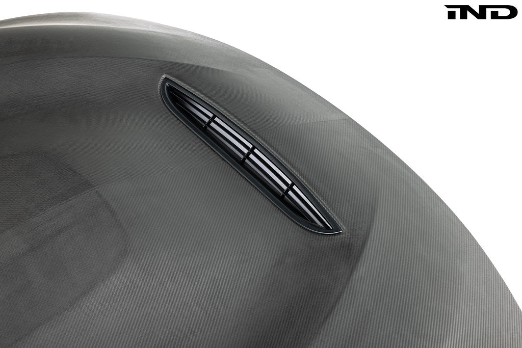 Alpha-N F82 M4 carbon GTS hood in raw carbon fiber on white background