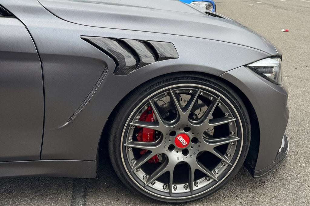 Alpha N F82 M4 Carbon Vented Front Fender Set installed, showcasing sleek carbon fiber exterior fenders on a BMW M4.