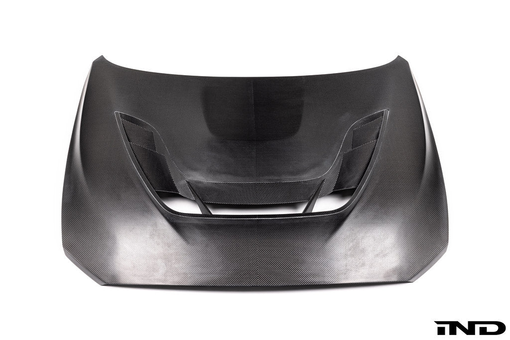 Alpha N F87 M2 Carbon Corse vented hood in white, showing the exterior design and venting details on a plain background.