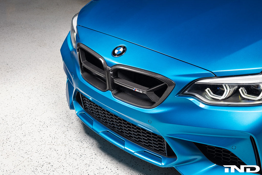 Alpha N F87 M2 Competition carbon front grille installed on exterior of the vehicle, showcasing sleek, lightweight design and craftsmanship.