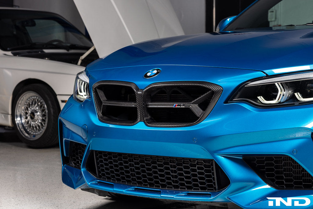 Alpha N F87 M2 Competition CS Carbon Corse front grille installed on the exterior of the car, showcasing its sleek, lightweight design.