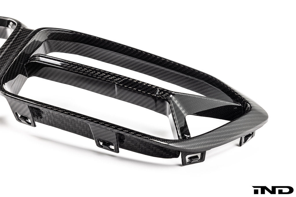 Alpha N F87 M2 Competition CS Carbon Corse front grille installed on a white background, showcasing its sleek exterior design.