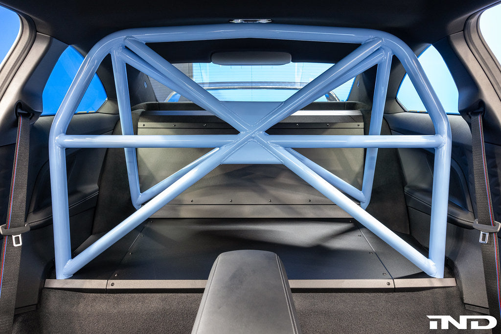 Alpha-N G87 M2 bolt-in harness bar installed in car interior for enhanced safety and seating support.