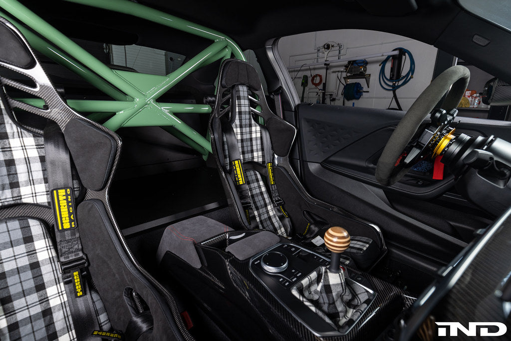 Interior view of Alpha N G87 M2 bolt-in harness bar installed in a vehicle for added safety and support.