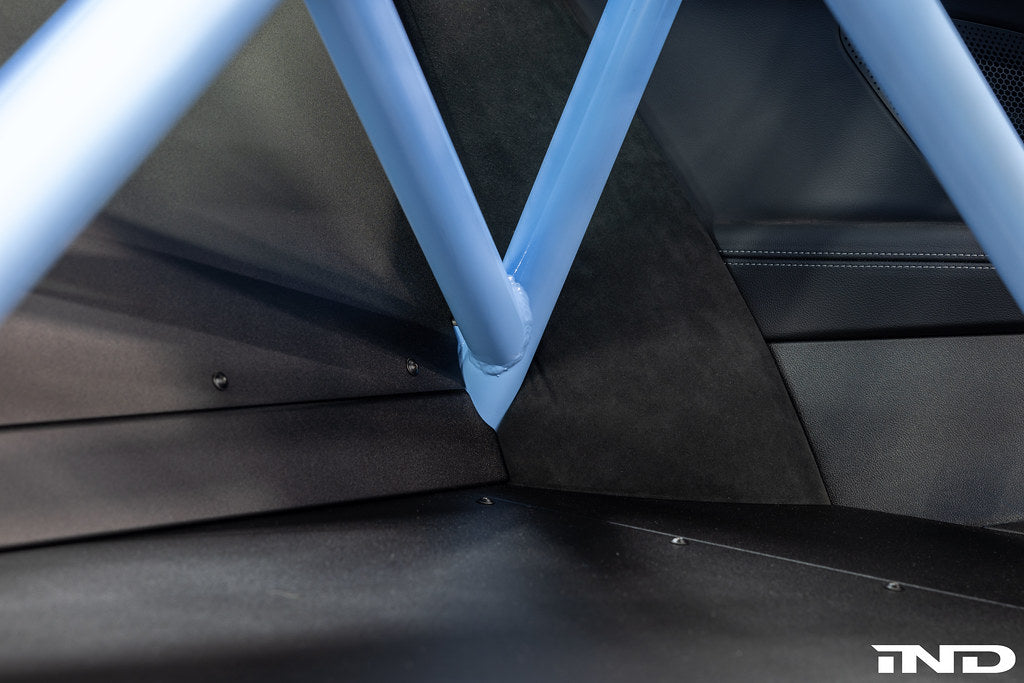 Interior view of Alpha N G87 M2 bolt-in harness bar installed in a car, providing additional safety support for racing harnesses.