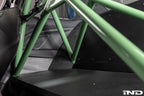 Alpha N G87 M2 bolt-in harness bar installed inside car interior, providing secure attachment points for racing harnesses.