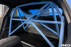 Alpha-N G87 M2 bolt-in harness bar installed in car interior, providing secure mounting point for racing harnesses.