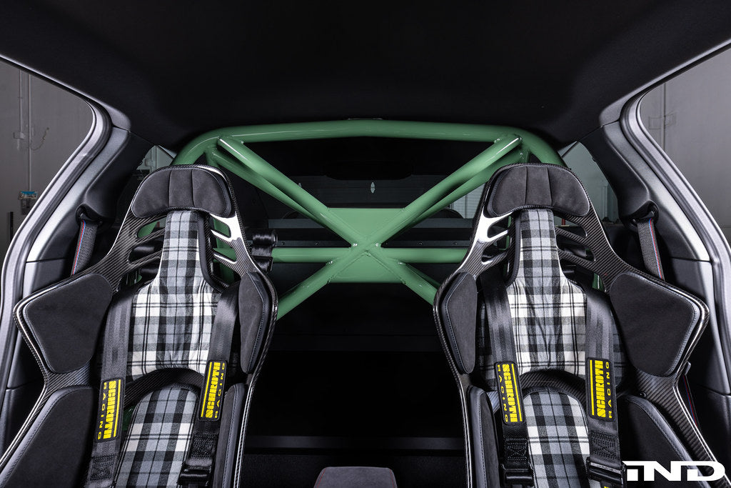 Alpha N G87 M2 bolt-in harness bar installed in car interior for added safety and support during racing or driving.