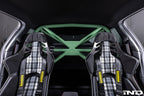 Alpha N G87 M2 bolt-in harness bar installed in car interior for added safety and support during racing or driving.