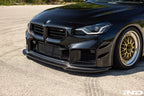 Alpha N G87 M2 carbon adjustable front lip exterior upgrade installed on a vehicle, showcasing its sleek design and class 3 style.