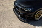 Alpha N G87 M2 carbon adjustable front lip installed on a vehicle, showcasing a sleek exterior upgrade with a Class 3 design.
