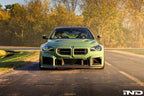 Alpha N G87 M2 carbon adjustable front lip installed on a BMW G87 M2, enhancing the vehicle's sporty exterior with a sleek design.