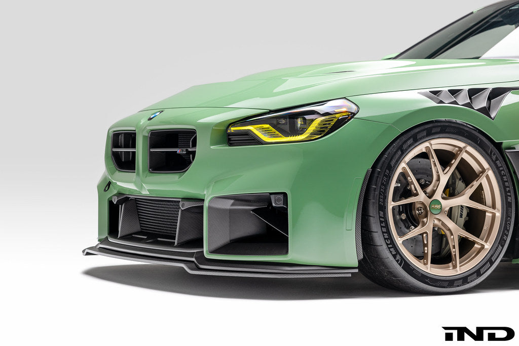 Alpha N G87 M2 carbon adjustable front lip installed on a BMW G87 M2, showcasing its sleek exterior design and aerodynamic features.