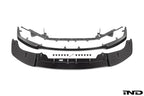 Alpha N Alpha-N G87 M2 Carbon Adjustable Front Lip Class 3 installed on a vehicle, showcasing its sleek white design and aerodynamic style.