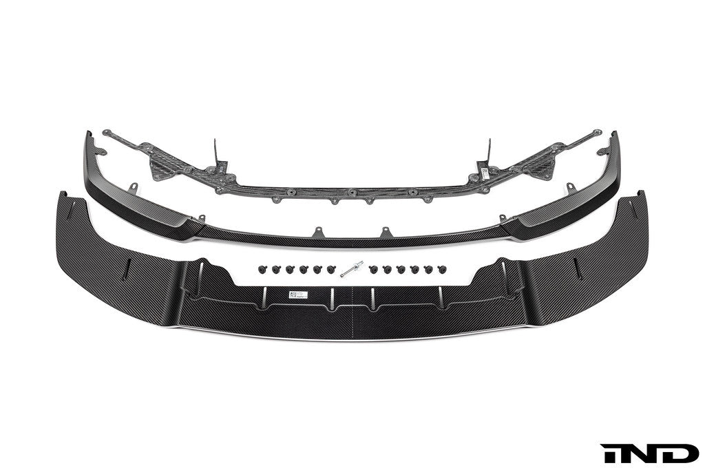 Alpha N Alpha-N G87 M2 Carbon Adjustable Front Lip Class 3 installed on a vehicle, showcasing its sleek white design and aerodynamic style.