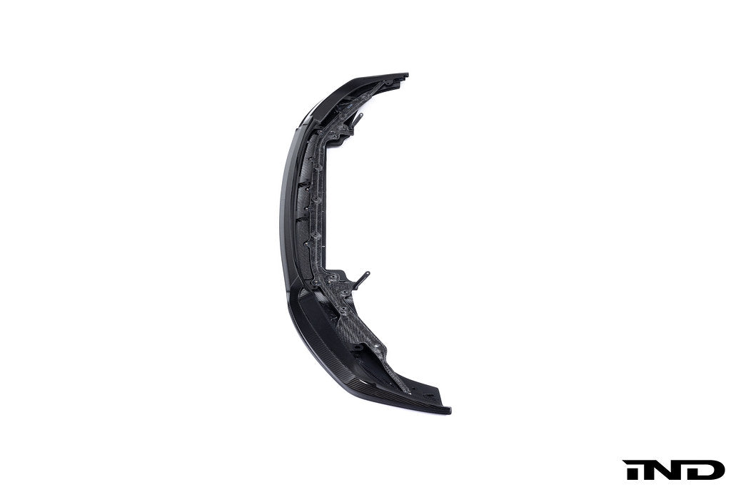 Alpha-N G87 M2 carbon adjustable front lip, Class 3, mounted on a white background, showcasing its aerodynamic design and finish.