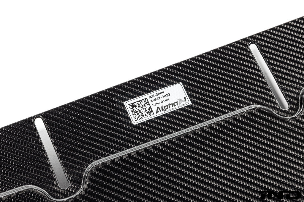 Alpha-N G87 M2 carbon adjustable front lip installed on a vehicle, showcasing its sleek design and Class 3 exterior style.