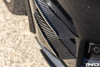 Alpha N G87 M2 Carbon bumper canard set installed on car, showcasing aerodynamic exterior upgrade with sleek carbon fiber design.