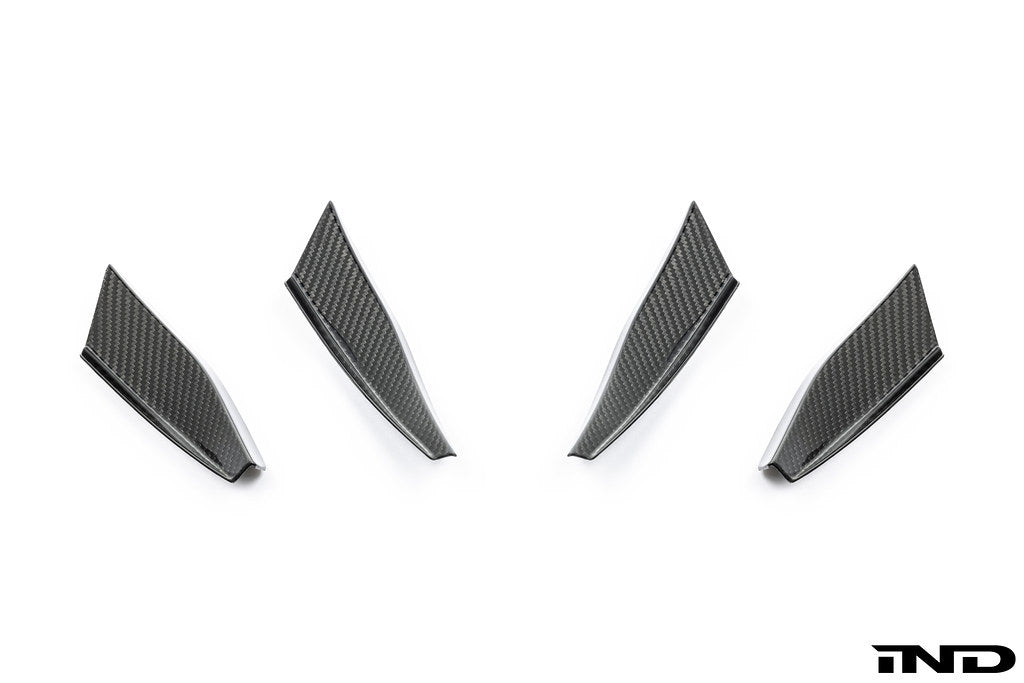 Alpha N G87 M2 carbon bumper canard set installed on white background, showcasing aerodynamic exterior car enhancements.