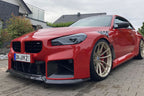 Alpha N G87 M2 Carbon Clubsport front lip installed on exterior of BMW G87 M2, showcasing sporty aftermarket car modification.