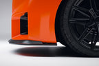 Alpha N G87 M2 Carbon Clubsport front lip installed on exterior of car, showcasing sleek aerodynamic design and glossy finish.