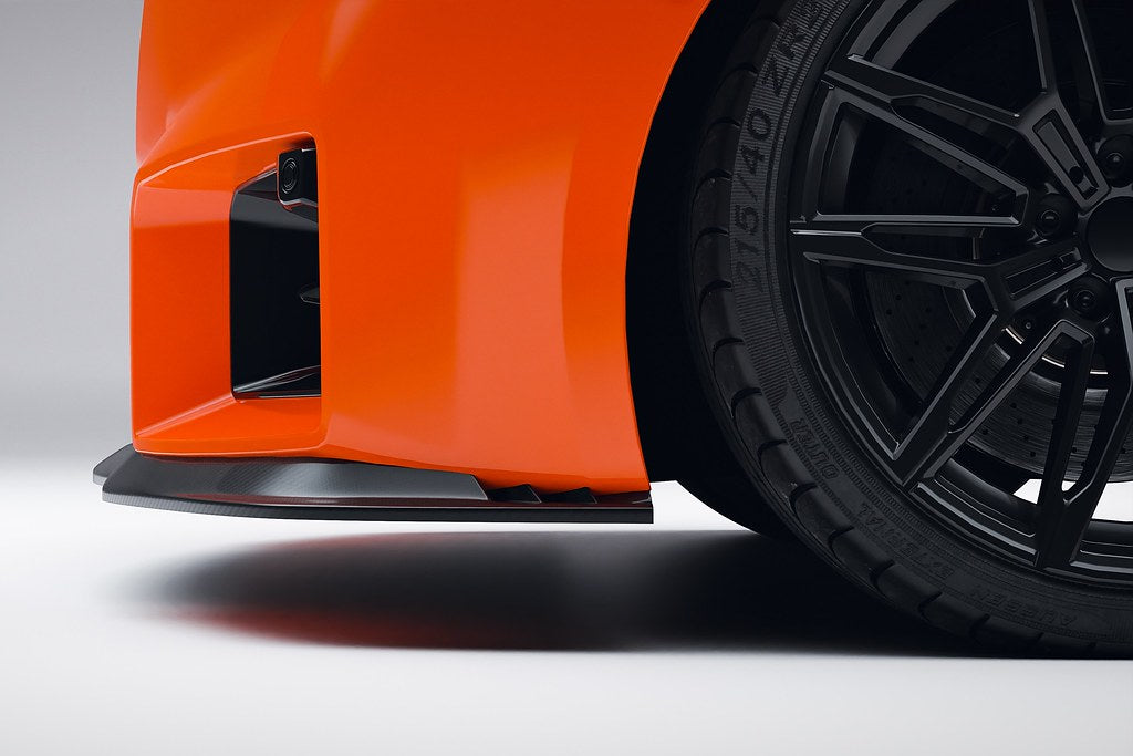 Alpha N G87 M2 Carbon Clubsport front lip installed on exterior of car, showcasing sleek aerodynamic design and glossy finish.
