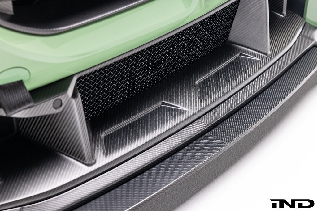 Alpha N G87 M2 carbon front center bumper trim installed on vehicle exterior, showcasing sleek, lightweight design.
