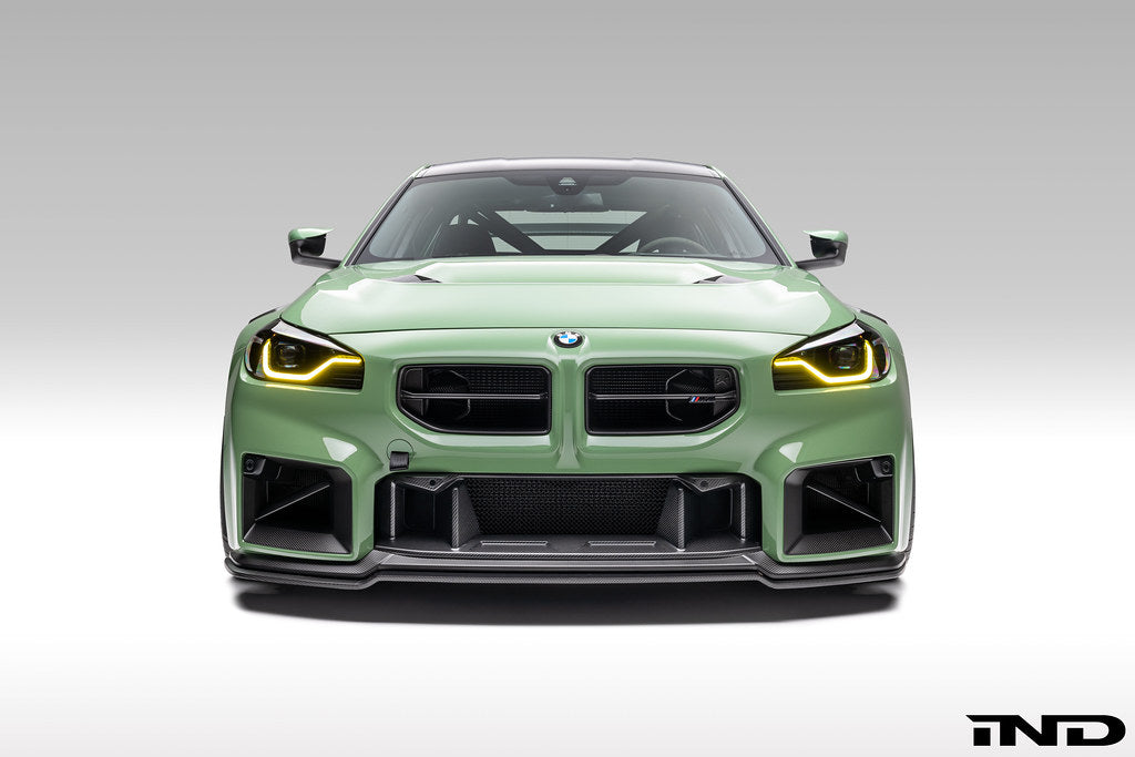 Alpha N G87 M2 carbon front center bumper trim installed on vehicle, showcasing sleek exterior automotive accessory.