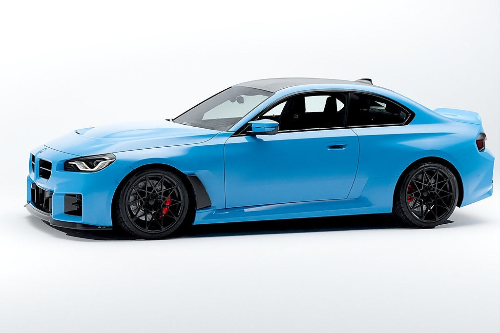 Alpha N G87 M2 carbon front fender set V2 with blades installed on a car, showcasing sleek, lightweight exterior design.