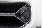 Alpha-N V2 Carbon Front Grille installed on an Alpine White BMW G87 M2, front view showcasing the aggressive motorsport-inspired design and exposed carbon fiber construction.