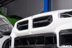Alpha-N V2 Carbon Front Grille installed on an Alpine White BMW G87 M2, front view showcasing the aggressive motorsport-inspired design and exposed carbon fiber construction.