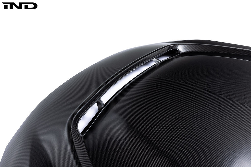 Alpha N G87 M2 carbon hood front vent insert installed on a car, showcasing its sleek design and lightweight carbon fiber material.