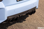 Alpha N G87 M2 carbon rear diffuser installed on a BMW M2 G87, showcasing the sleek exterior design and aerodynamic details.