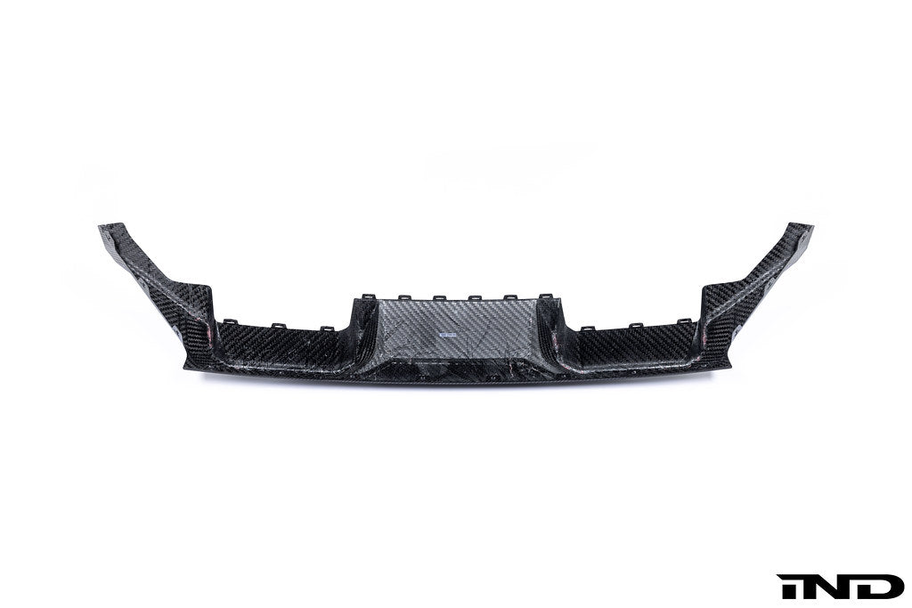 Alpha N G87 M2 carbon rear diffuser installed on a white background, showcasing its aerodynamic design and sleek carbon fiber finish.