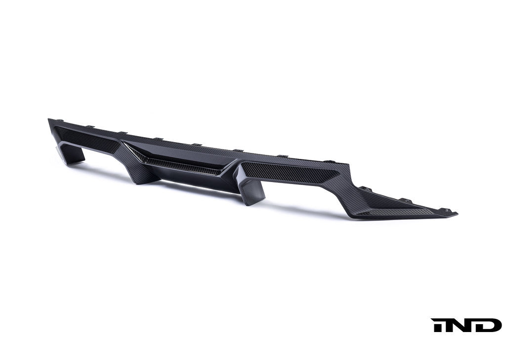 Alpha N G87 M2 carbon rear diffuser installed on a car, showcasing its sleek white finish and aerodynamic design.