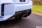 Alpha N G87 M2 carbon rear underbody floor kit installed on a BMW M2, showing sleek black carbon fiber exterior components.