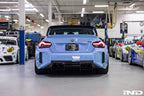 Alpha N G87 M2 carbon rear underbody floor kit installed on vehicle, showcasing lightweight aerodynamic exterior enhancement.