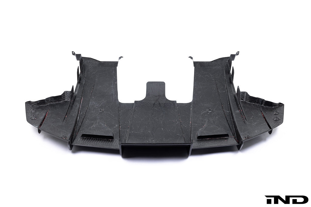 White Alpha N G87 M2 carbon rear underbody floor kit installed on a car, showing the sleek aerodynamic design against a plain background.