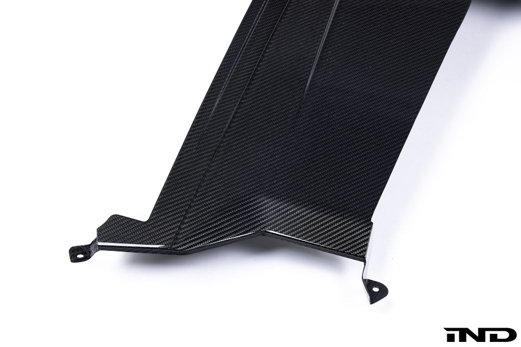 Alpha N G87 M2 carbon rear underbody floor kit installed on a car, showcasing lightweight aerodynamic design on a white background.