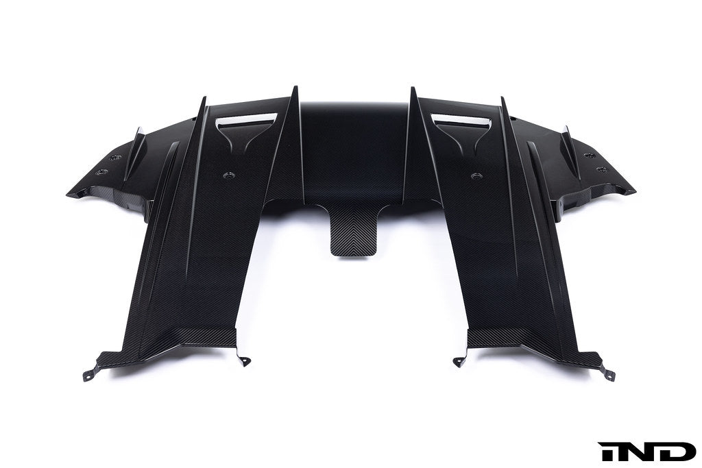 Alpha N G87 M2 Carbon rear underbody floor kit installed on a white background, showcasing sleek aerodynamic exterior upgrade.