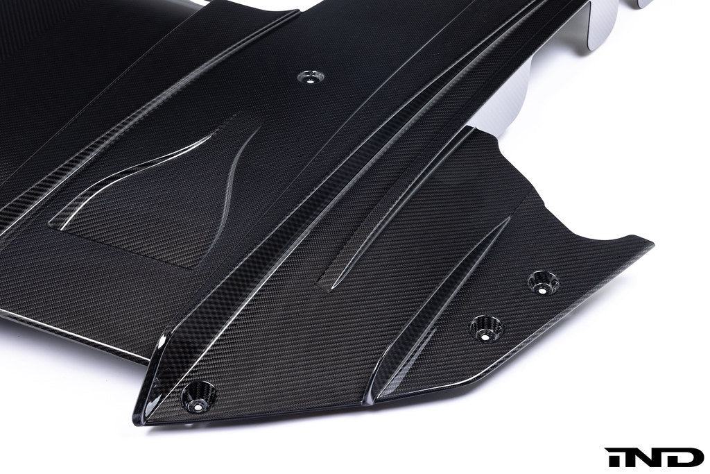 Alpha N G87 M2 carbon rear underbody floor kit installed on a car, shown against a white background.