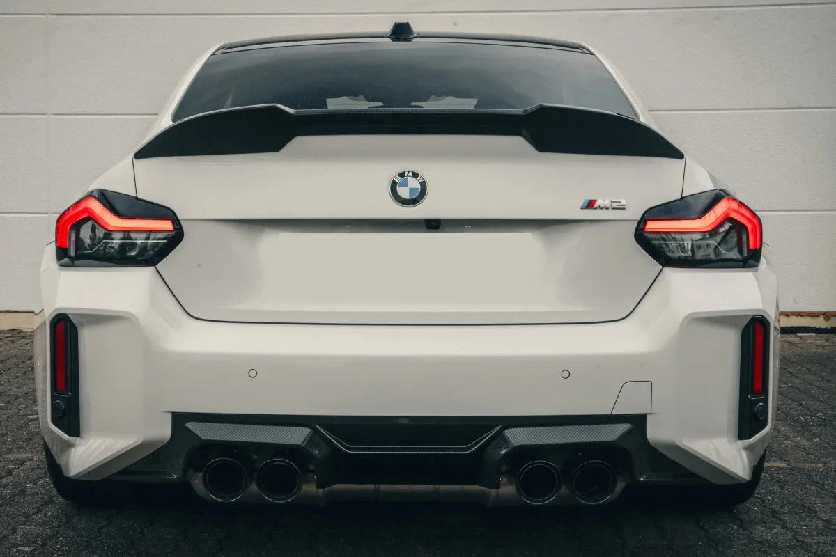 Alpha-N G87 M2 carbon trunk spoiler installed on a BMW M2, showcasing a sleek, aerodynamic exterior car accessory.