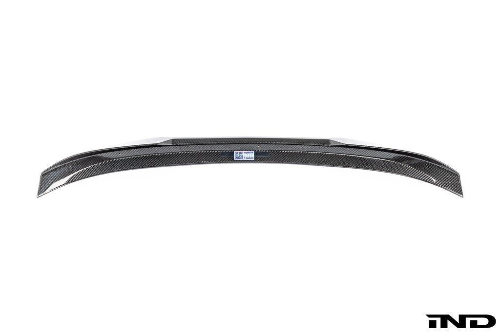 Alpha N G87 M2 carbon trunk spoiler mounted on a white background, showcasing the sleek exterior design and aerodynamic features.