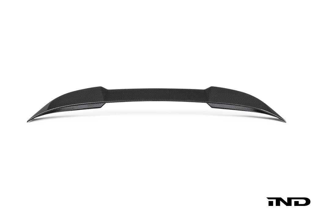 Alpha-N G87 M2 carbon trunk spoiler installed on white background, showcasing sleek exterior design and aerodynamic features.