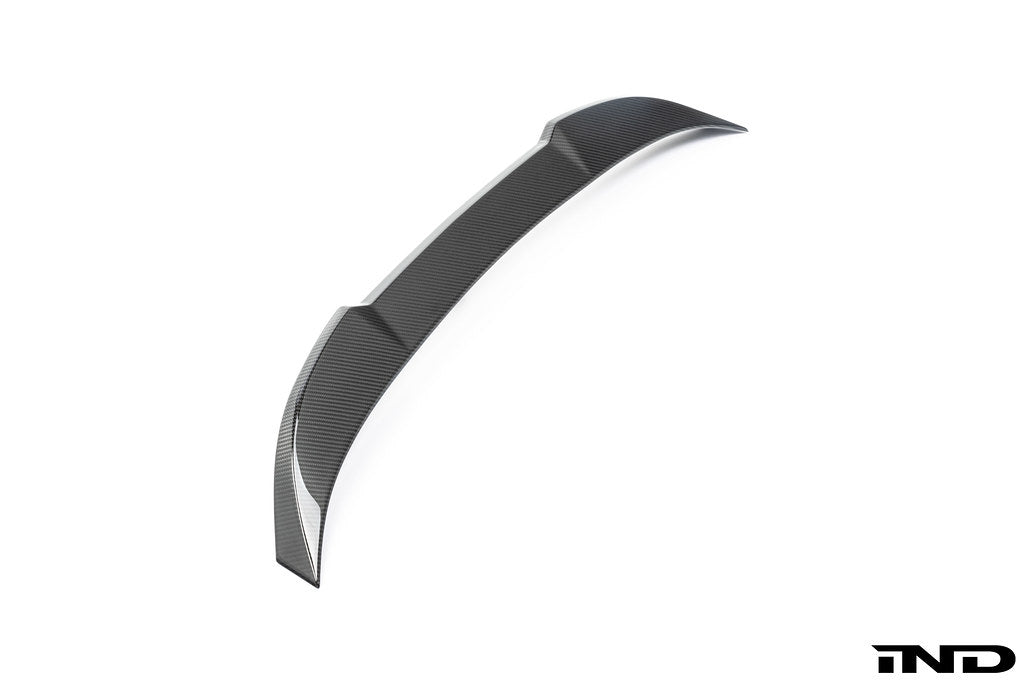 Alpha-N G87 M2 carbon trunk spoiler mounted on white background, highlighting sleek exterior design and aerodynamic features.